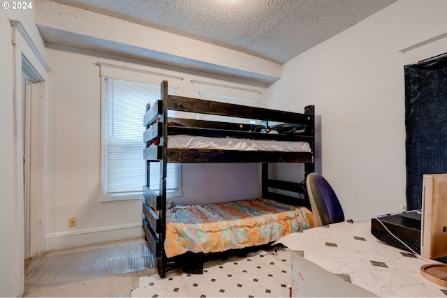 carpeted bedroom with a textured ceiling