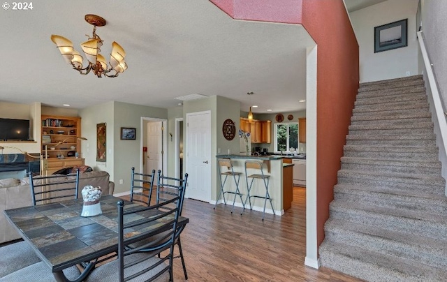 dining room featuring hardwood / wood-style floors and a chandelier