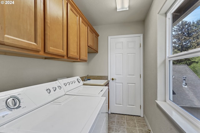 laundry room with cabinets, sink, and washer and dryer