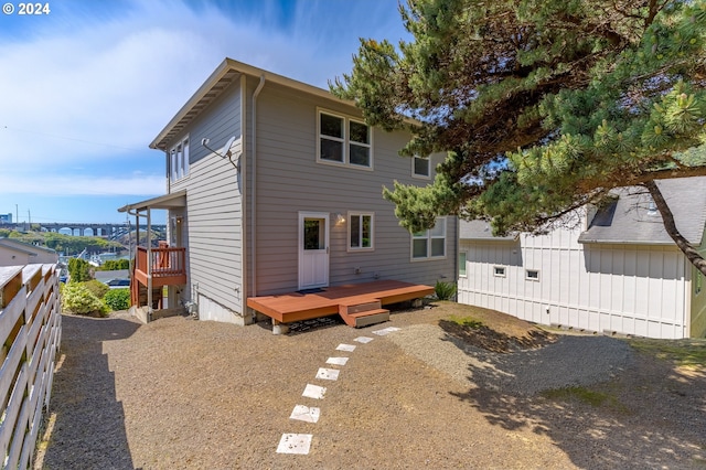 back of property featuring a wooden deck