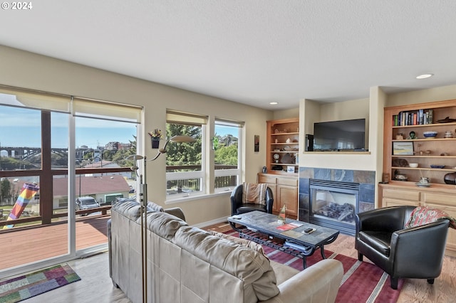 living room with a fireplace and light wood-type flooring