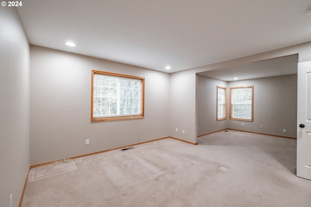 carpeted empty room with a wealth of natural light