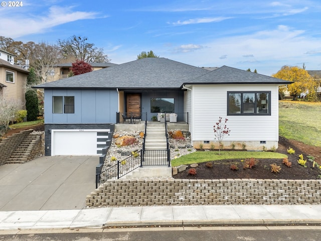 ranch-style home with a porch and a garage