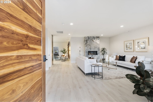 living room featuring a fireplace and light hardwood / wood-style floors