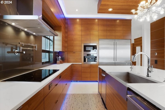 kitchen featuring built in appliances, light tile flooring, fume extractor, sink, and an inviting chandelier