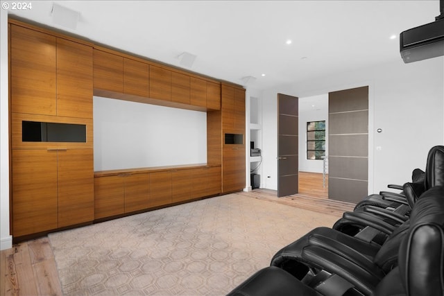 cinema room with light wood-type flooring