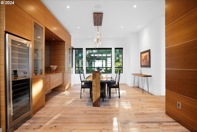 dining area featuring wine cooler and light hardwood / wood-style floors