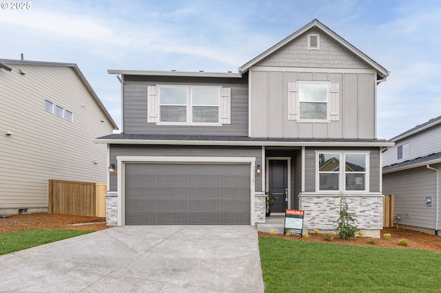 craftsman house featuring fence, an attached garage, concrete driveway, stone siding, and board and batten siding