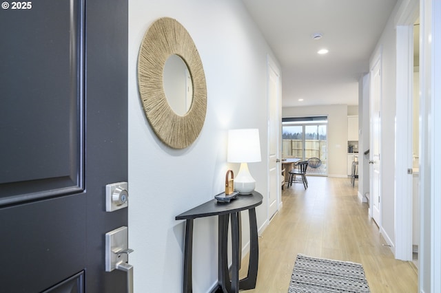 hall with recessed lighting, baseboards, and light wood-style flooring