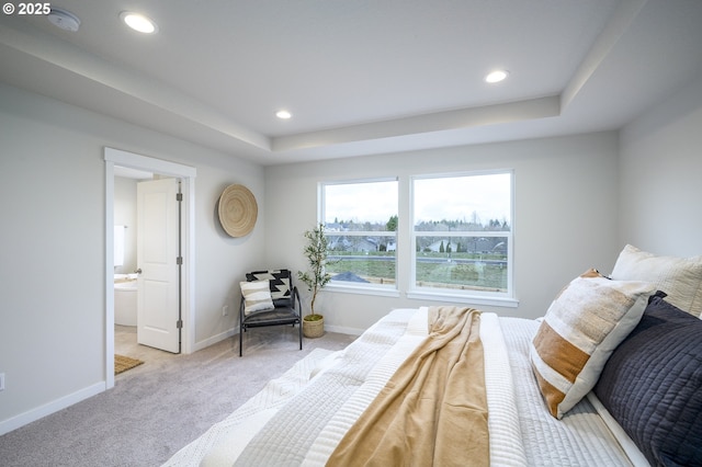 carpeted bedroom with ensuite bath, recessed lighting, and baseboards