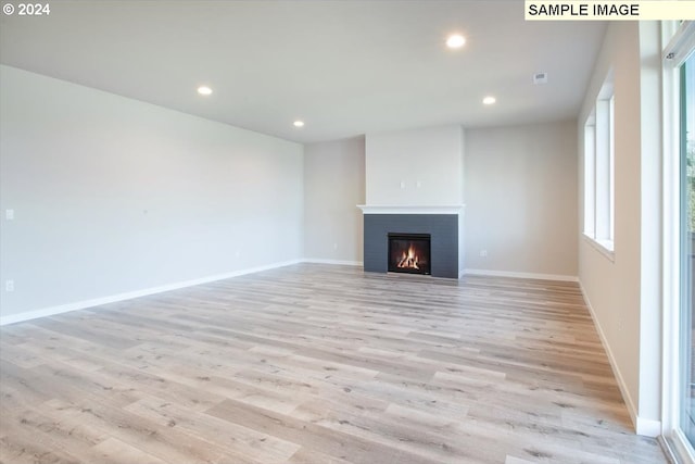 unfurnished living room featuring light hardwood / wood-style flooring