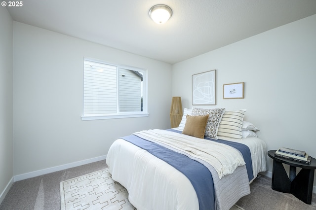 bedroom featuring baseboards and carpet floors