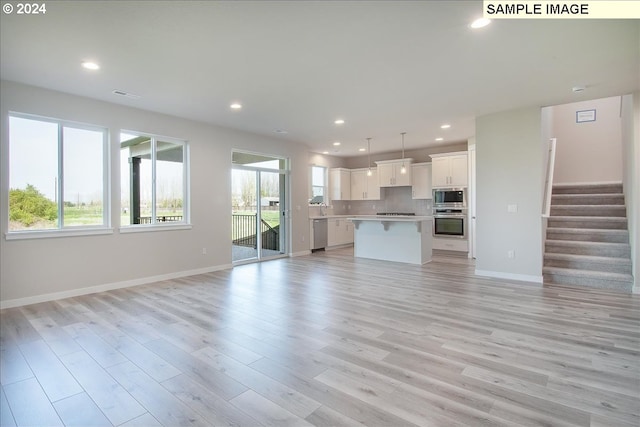 unfurnished living room featuring light hardwood / wood-style flooring