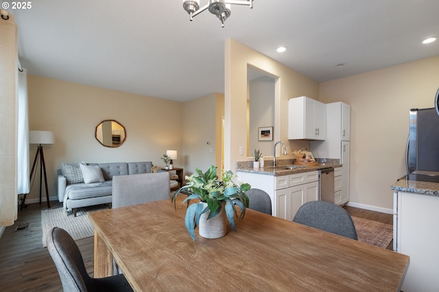 dining room featuring dark hardwood / wood-style flooring and sink