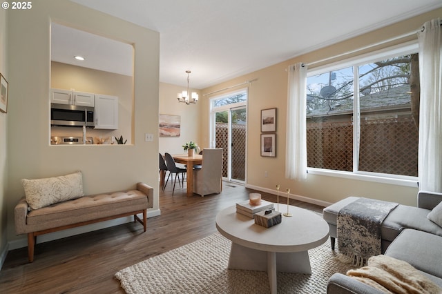 living room with dark hardwood / wood-style flooring and a notable chandelier