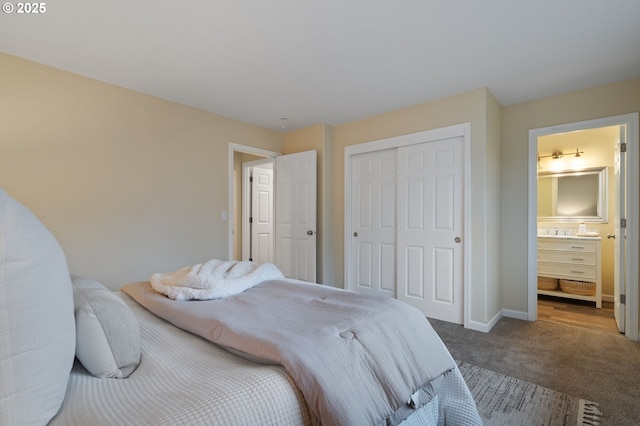 carpeted bedroom featuring ensuite bath and a closet