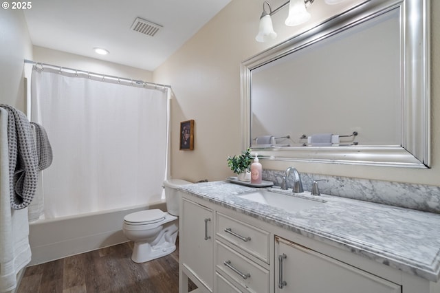 full bathroom with hardwood / wood-style floors, vanity, toilet, and shower / bath combo with shower curtain