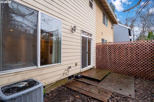 view of home's exterior featuring central AC and a wooden deck