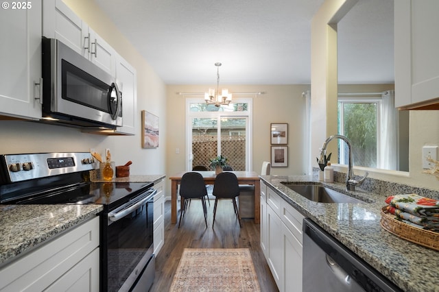 kitchen with white cabinets, appliances with stainless steel finishes, and sink