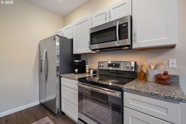 kitchen featuring stone counters, white cabinets, dark wood-type flooring, and appliances with stainless steel finishes