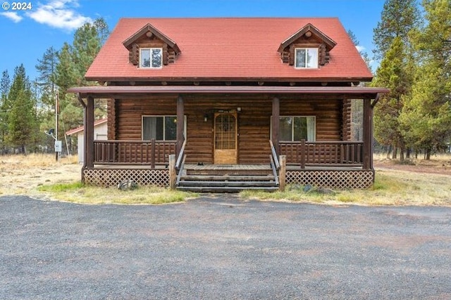 log cabin with covered porch