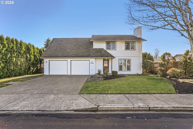 view of front of home featuring a front yard and a garage