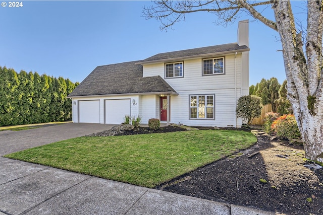 view of front of home featuring a garage and a front lawn