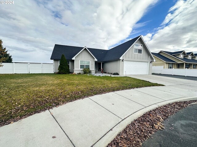 view of front of property with a garage and a front lawn