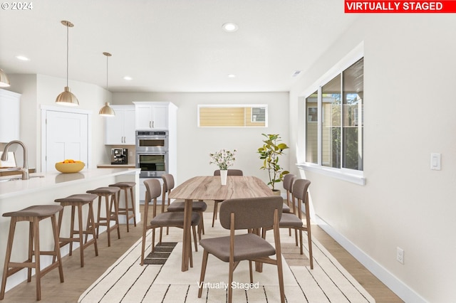 dining area featuring light hardwood / wood-style flooring and sink