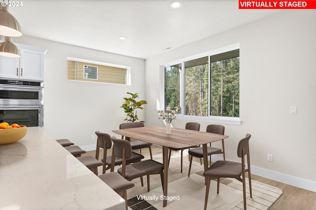 dining room with light hardwood / wood-style flooring