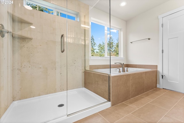 bathroom with shower with separate bathtub and tile patterned floors