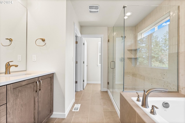 bathroom featuring tile patterned flooring, vanity, and separate shower and tub