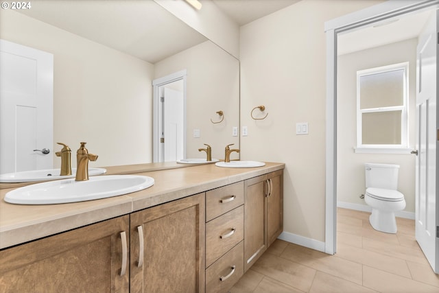 bathroom featuring tile patterned flooring, vanity, and toilet