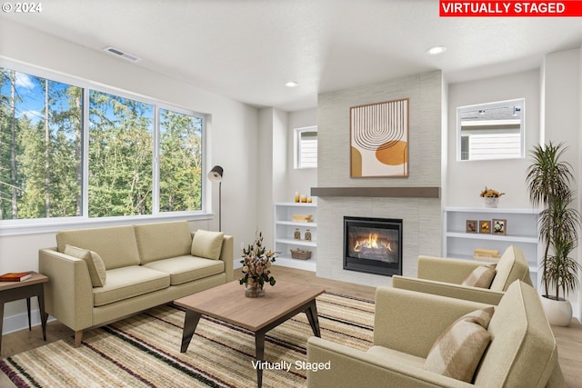 living room with wood-type flooring and a fireplace