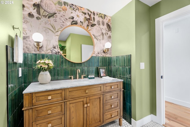 bathroom with tile walls, vanity, and wood-type flooring