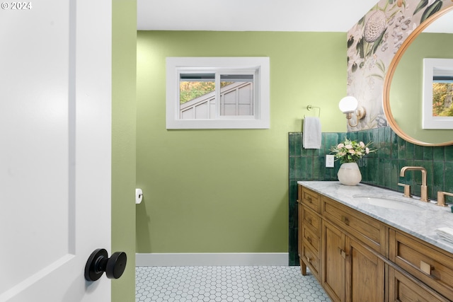 bathroom with vanity, decorative backsplash, and tile patterned floors