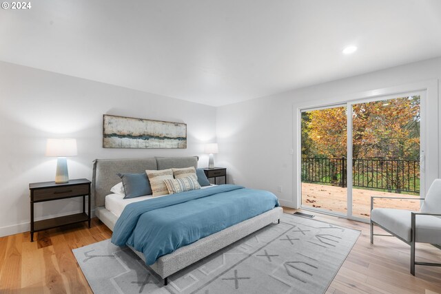 bedroom featuring access to outside and light hardwood / wood-style flooring