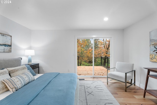 bedroom featuring light hardwood / wood-style floors and access to outside