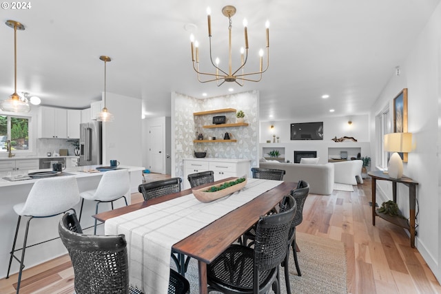 dining room with an inviting chandelier and light wood-type flooring