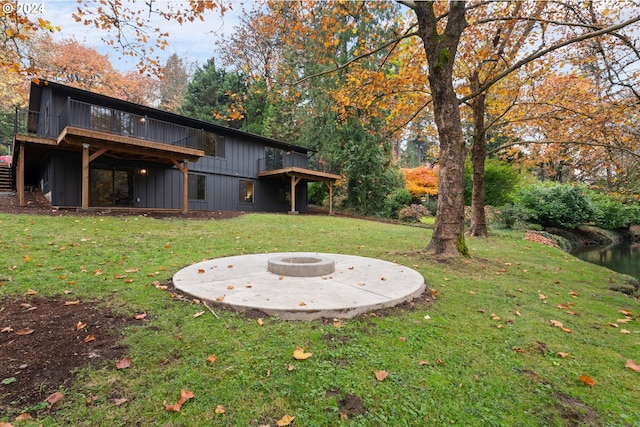 view of yard featuring an outdoor fire pit and a wooden deck