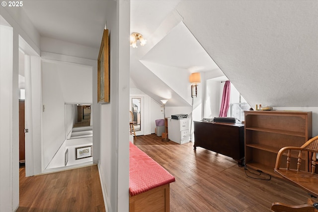 bonus room featuring vaulted ceiling and wood finished floors