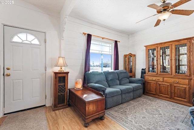 living area with light wood-style flooring and ceiling fan