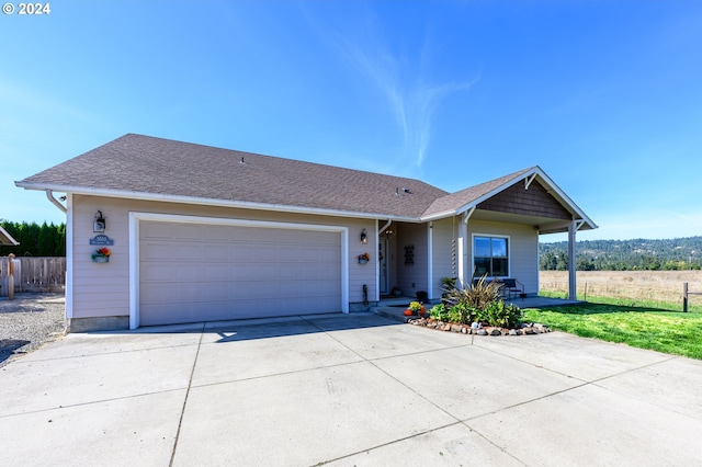 ranch-style house with a garage and a front lawn