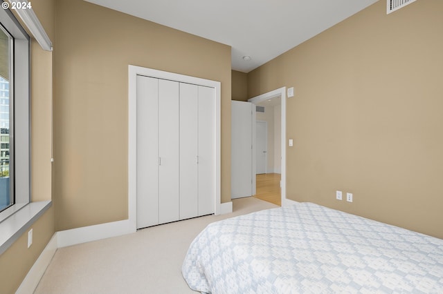 carpeted bedroom with a closet