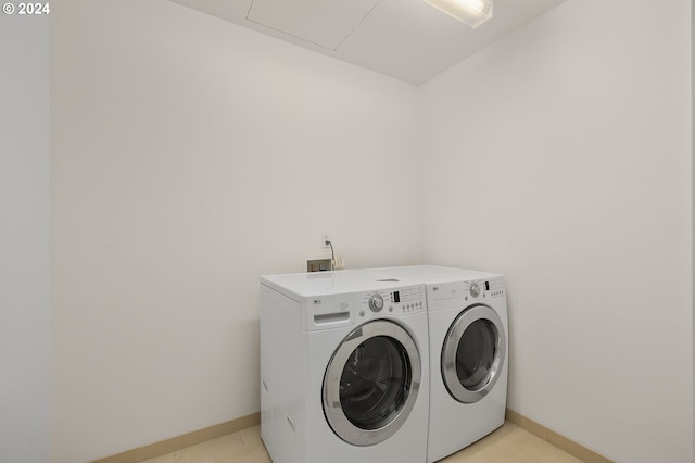 washroom with washing machine and clothes dryer