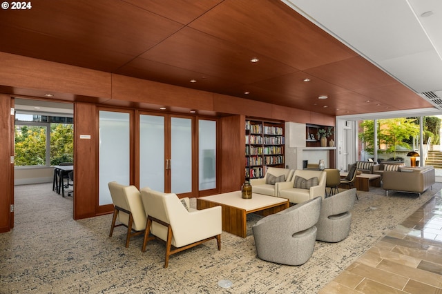 living room with wood ceiling and a wealth of natural light