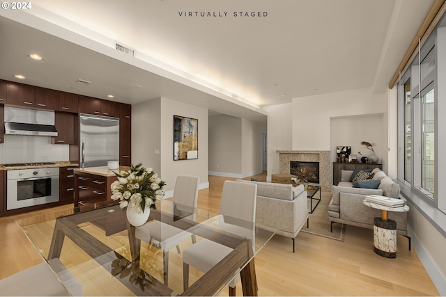 dining space with light hardwood / wood-style floors