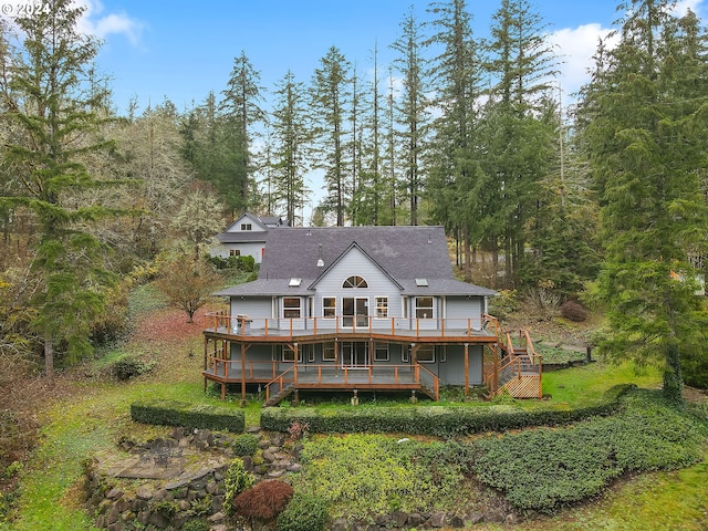 back of property with a wall mounted air conditioner and a wooden deck