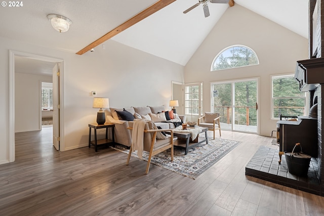 living room with ceiling fan, beamed ceiling, high vaulted ceiling, and wood-type flooring