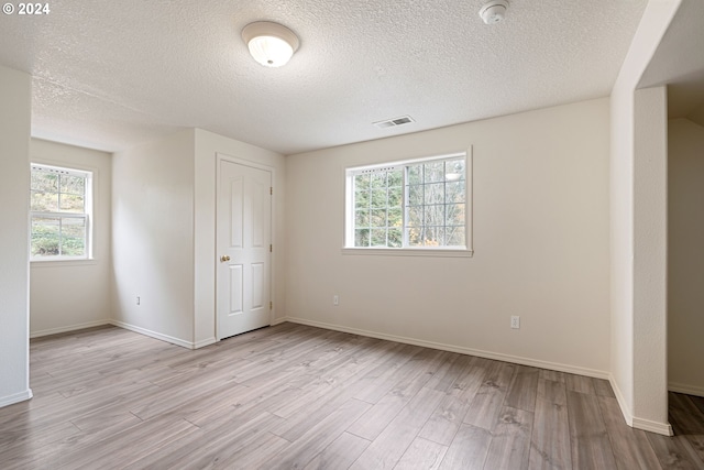 unfurnished bedroom featuring a textured ceiling and light wood-type flooring